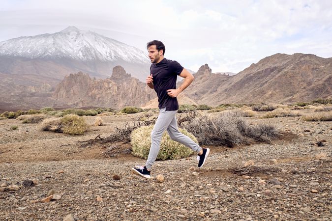 Focused man running in mountains