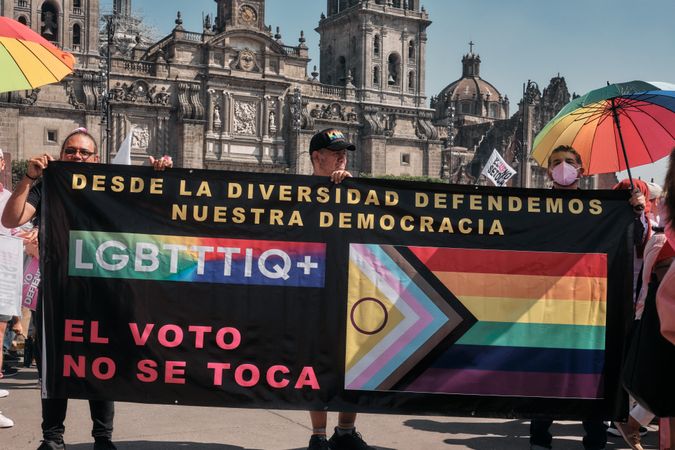 Mexico City, Mexico - February 26th, 2022: Group of people holding banner at protest in Zocalo
