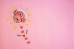Pink doughnuts in a flower shape made with candies