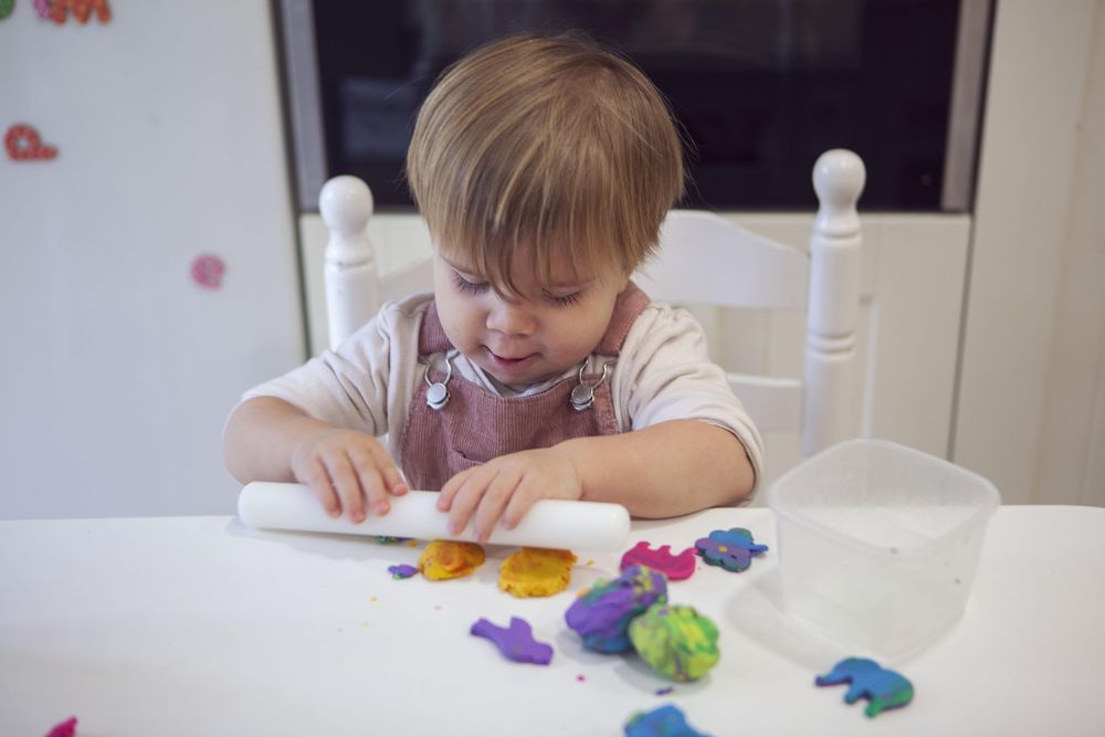 Boy playing play dough