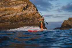 Woman on paddleboard floating in sea