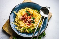 Pasta with cheese on counter with copy space