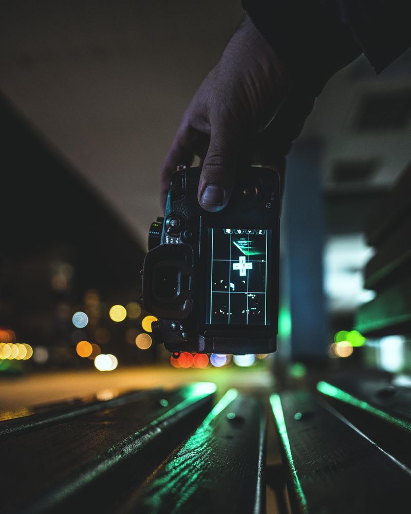 Person holding dark video camera