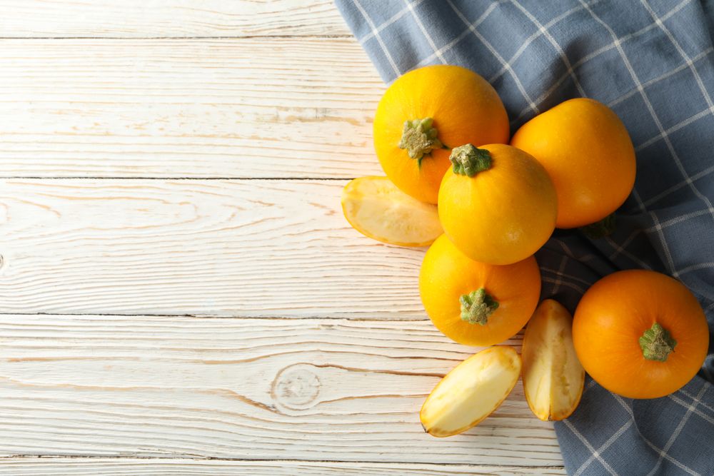 Round zucchini and napkin on wooden table