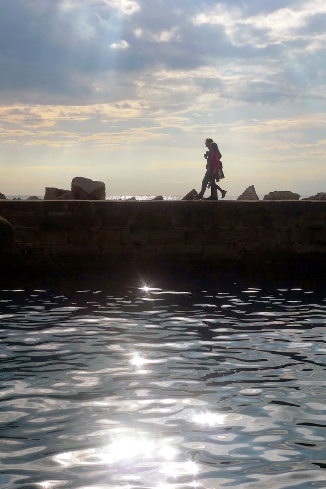Couple walking along a pier