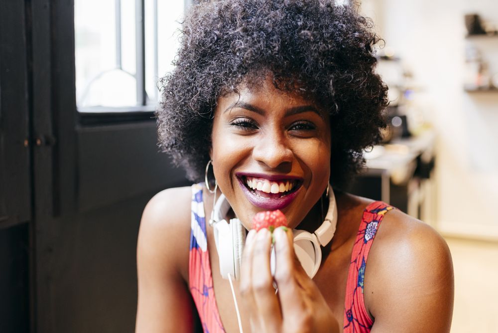 Happy Black woman in cafe