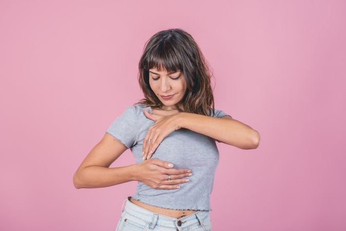 Woman doing a Breast Self-Exam (BSE).