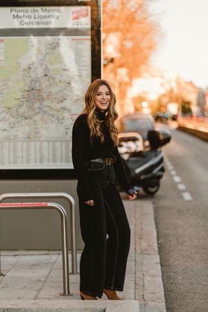 Stylish woman standing near metro station