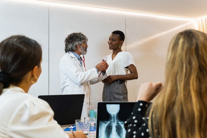 Group of doctors examining patient in hospital