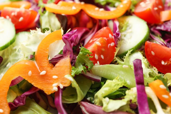 Fresh salad with sesame on whole background, close up