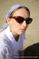 Portrait of blonde woman with headscarf and sunglasses 0yMKG0