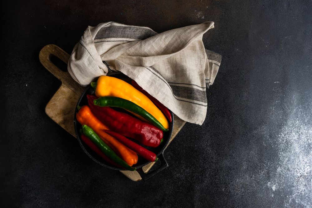 Fresh raw bell peppers in a pan with copy space