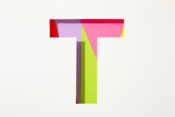Multicolor letter T on blank background, space for text