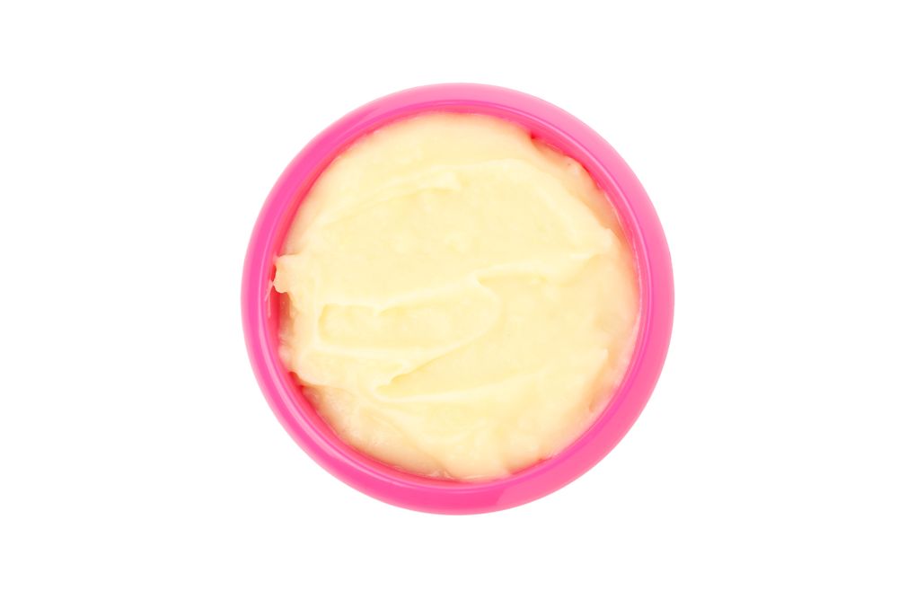 Bowl with healthy baby food isolated on plain background