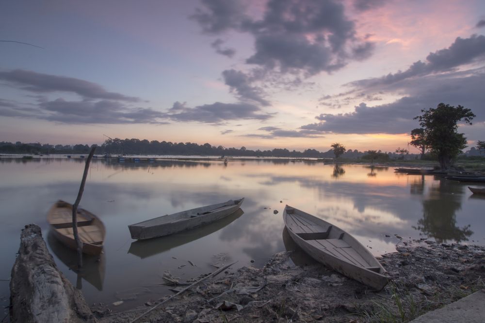 Boats on lake during sunset