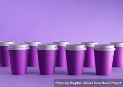 Disposable coffee cups on purple background 48ZWX0