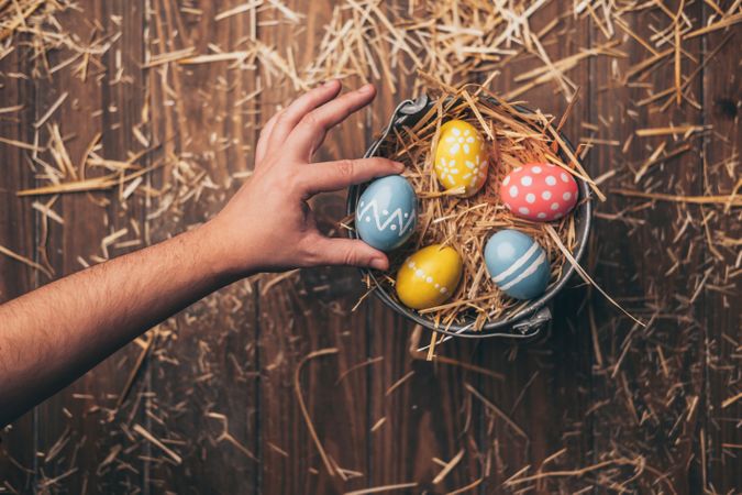 Hand placed Easter eggs on wooden stump