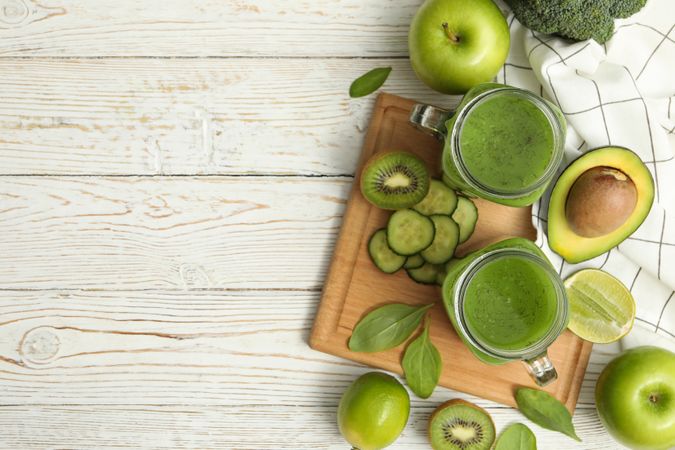 Concept of healthy food with smoothie, vegetables and fruits on wooden table