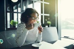 Content woman smiling in cafe with coffee in hand