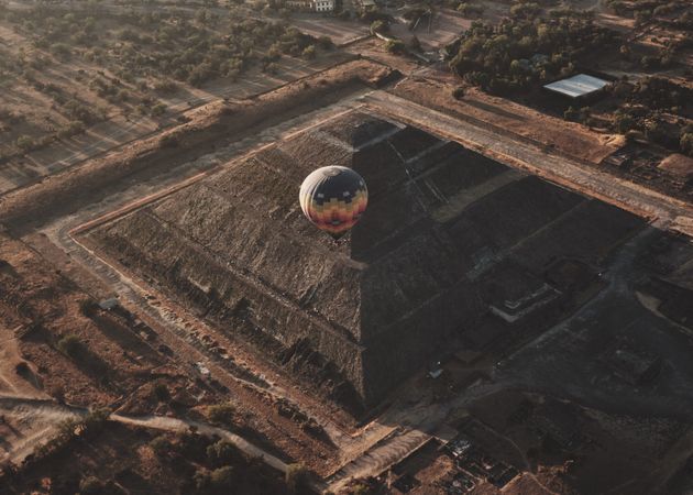 View of one hot air balloon in flight over pyramid in Teotihuacan Valley