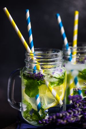 Side view of lemonade with lavender, lemon and mint