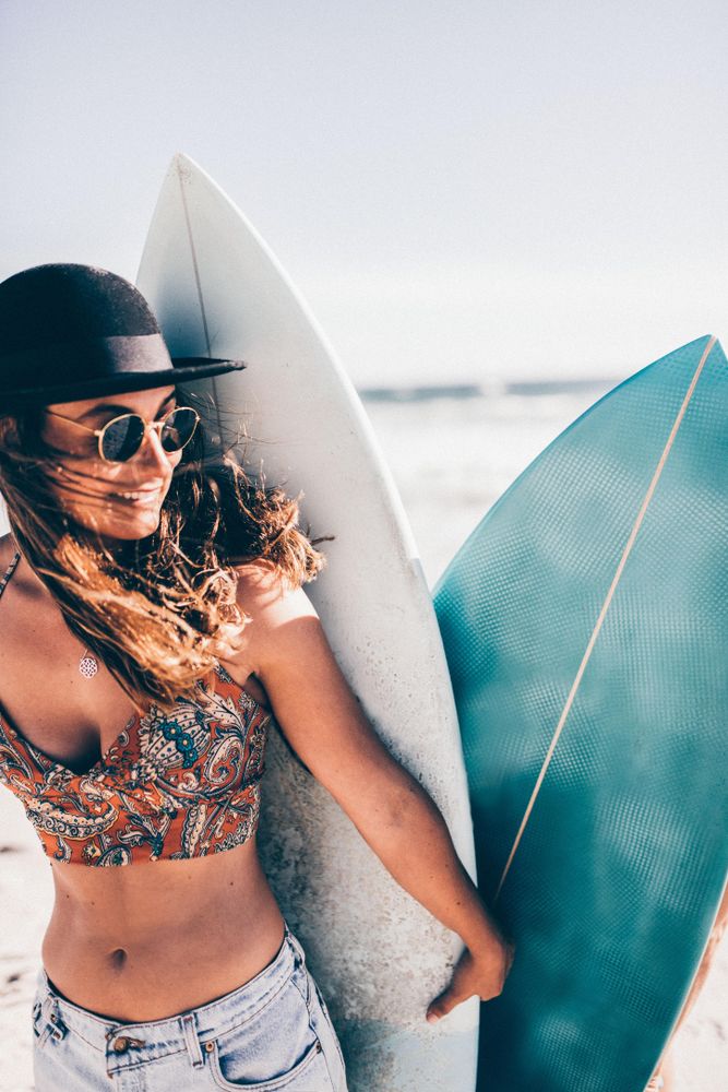 Young woman with two surf boards