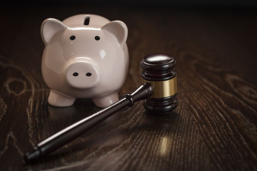 Gavel and Piggy Bank on Table