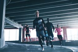 Group of people running around a curve on the track