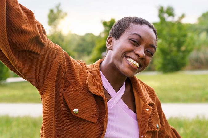 Portrait of a joyful Black woman carefree outdoors in the parkland