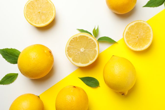 Fresh lemons on two tone background, top view. Ripe fruit