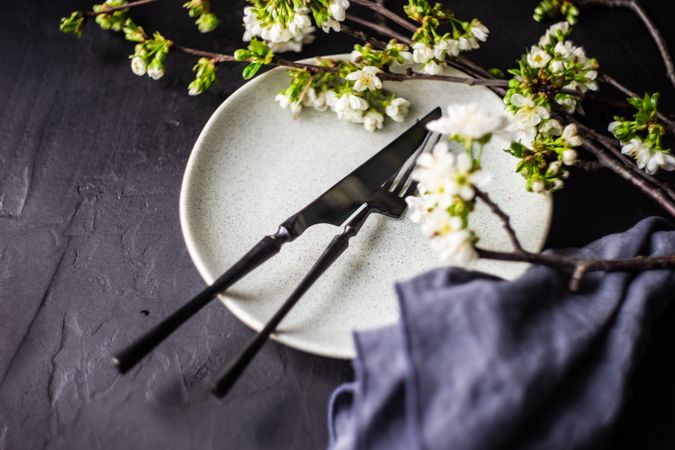 Spring table setting with buds around plate