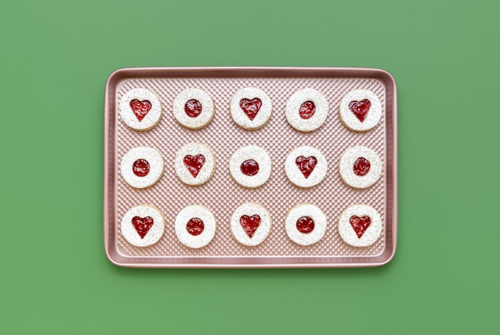 Homemade linzer cookies on a pink tray, top view
