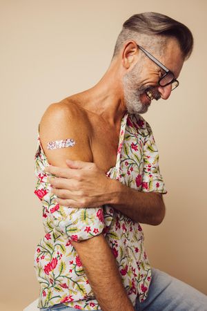 Man showing his arm after receiving covid-19 vaccine
