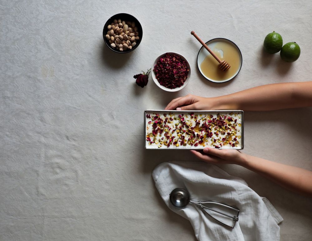 Crop hands putting cheesecake on table