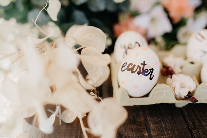 Easter eggs hand painted by children with messages in an egg cup
