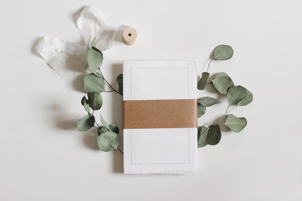 Cotton paper diary with rough edges, craft belly band, tape isolated on table
