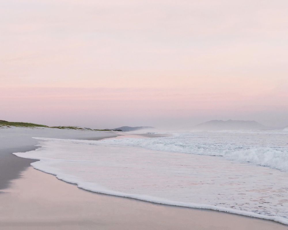Soft waves under pink skies