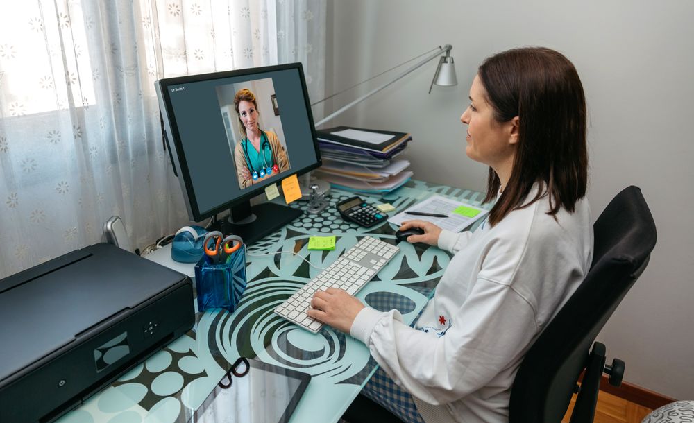Woman talking on video call with her doctor
