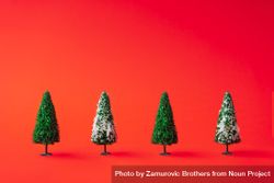 Snowy Christmas trees on red background 48dxJ4