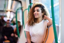 Arab woman sitting in subway car