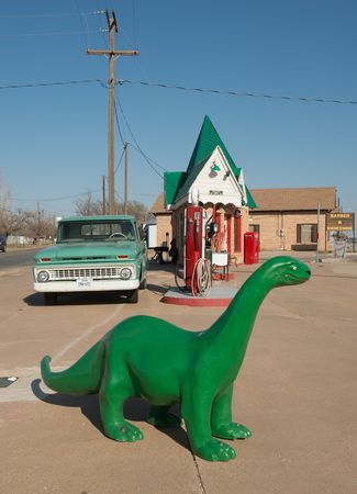 A vintage Chevrolet and dinosaur at a restored old Sinclair gasoline station in Snyder, Texas