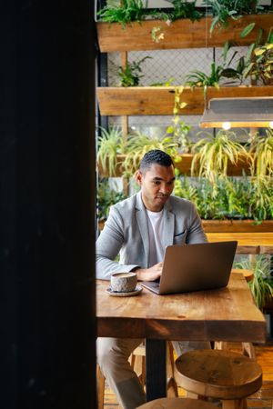 Man working on laptop at cafeteria