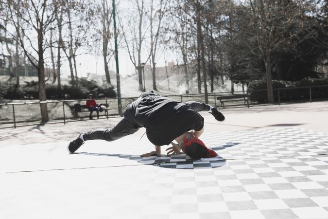 Man dancing break dance in park