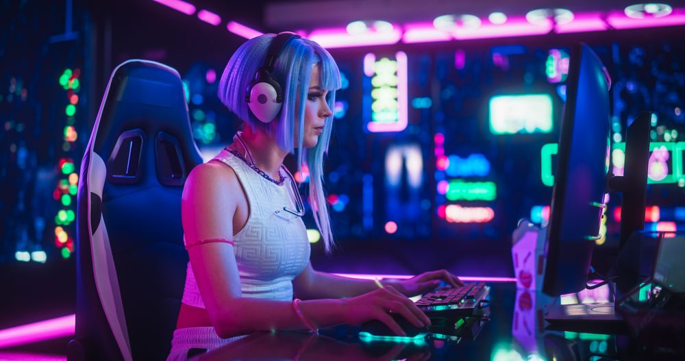 Professional Female eSports Gamer Playing Video Game on a Computer with a Curved Ultrawide Monitor.