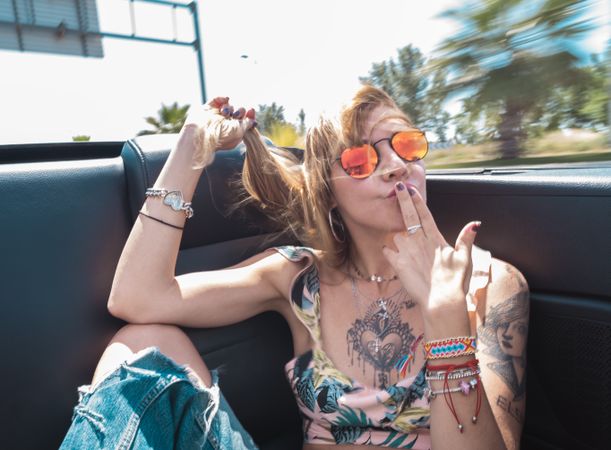 Young woman riding cabriolet