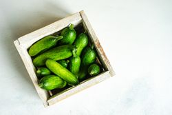 Box of small cucumbers