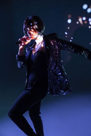 Stylish woman singing on stage