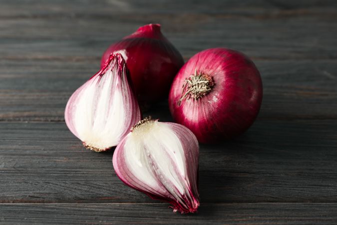 Composition with red onion on wooden background