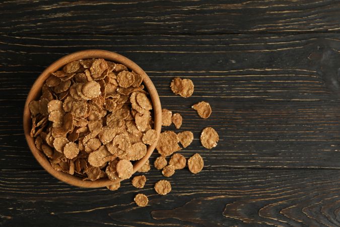 Bowl of tasty muesli on wooden background