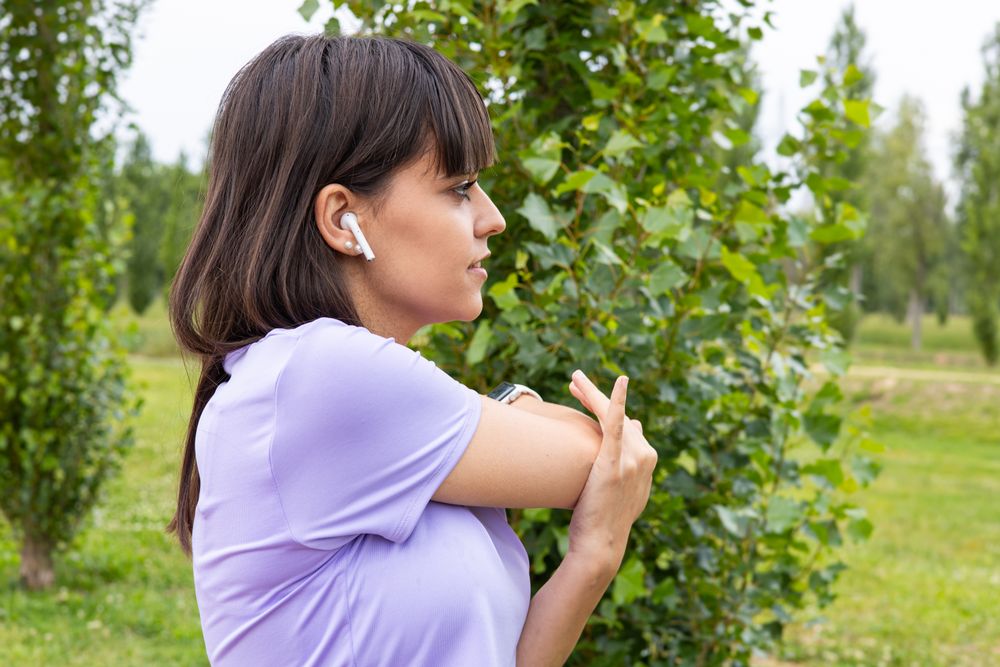 Woman arm stretching exercise outdoors